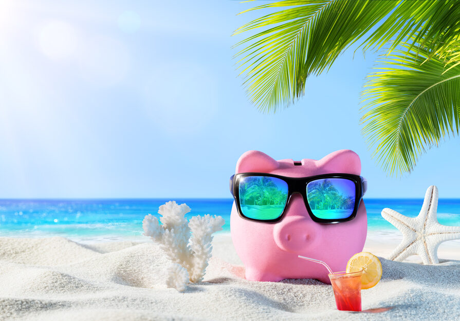 Piggy,Bank,With,Drink,On,The,Palm,Beach,-,Holidays